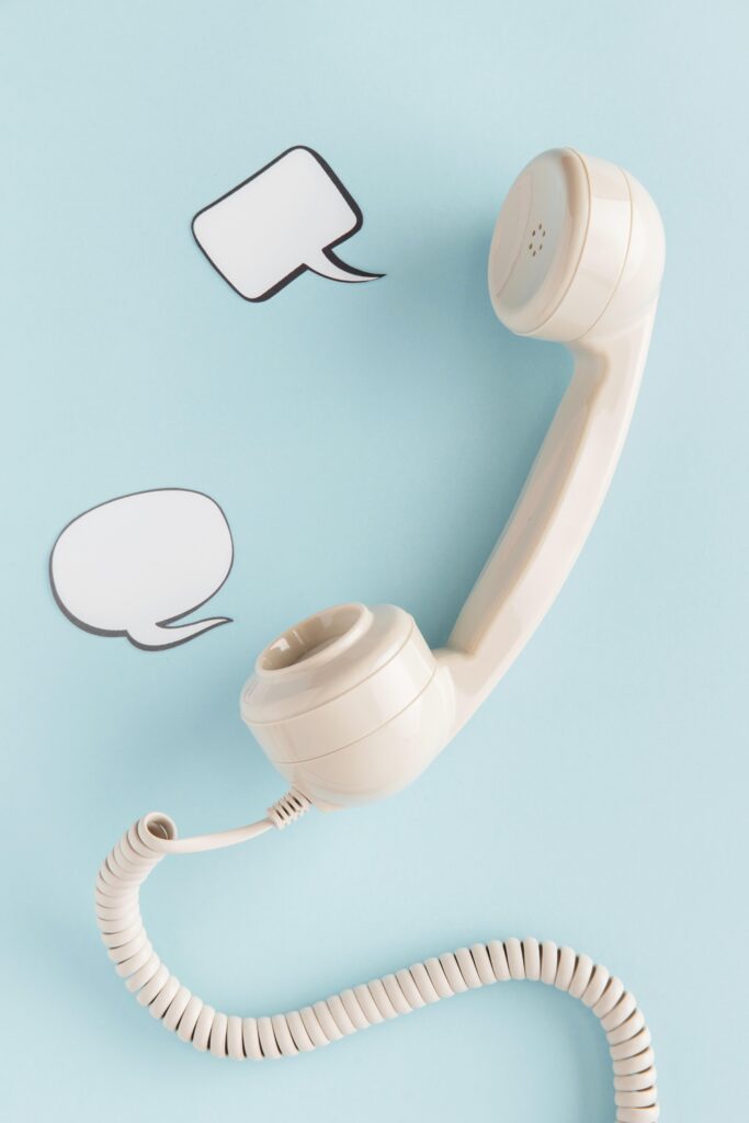 Vintage telephone receiver with speech bubbles on a blue background, inviting contact for GrowEasy, the best digital marketing agency in Haldwani.